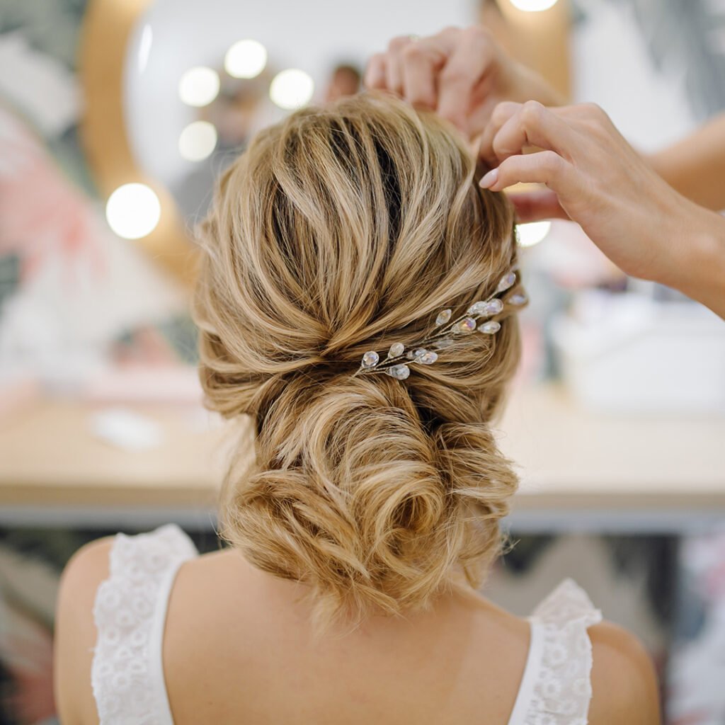 Hairdresser woman weaving braid hair, wedding styling.